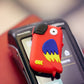 walkie perroquet rouge posé sur un terminal de paiement